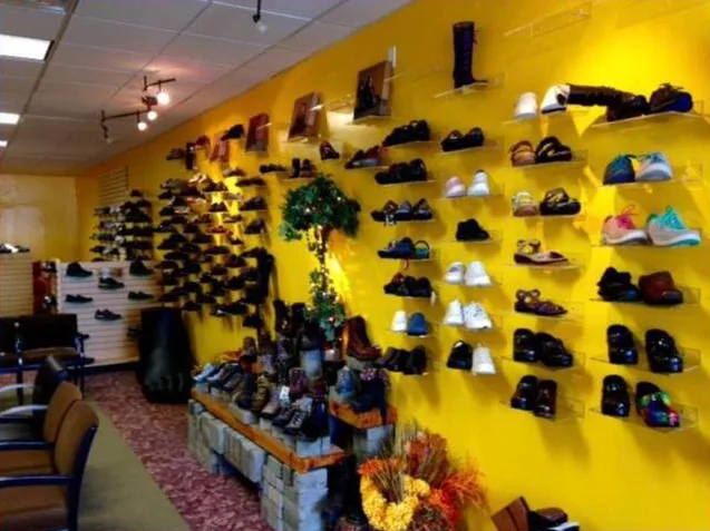 Inside Perfect Shoes Plus: a bright yellow wall of shoes